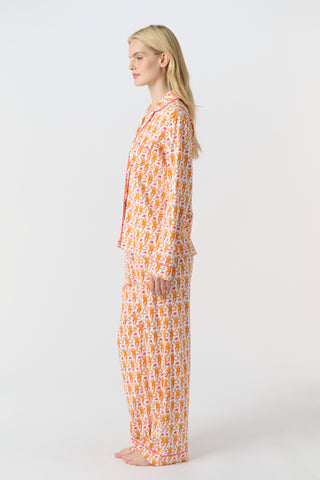 Playful orange monkeys and pink butterflies pop on a white background. The Monkey Polo Pajamas bring whimsy and color to your pima cotton collection, making this matching set a standout favorite for fun, lively sleepwear.