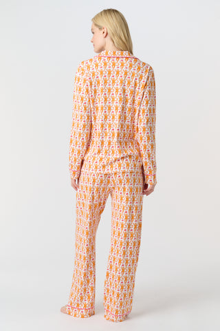 Playful orange monkeys and pink butterflies pop on a white background. The Monkey Polo Pajamas bring whimsy and color to your pima cotton collection, making this matching set a standout favorite for fun, lively sleepwear.