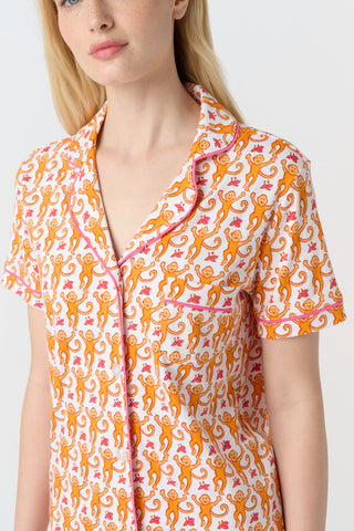 Playful orange monkeys and pink butterflies pop on a white background. The Monkey Polo Pajamas bring whimsy and color to your pima cotton collection, making this matching set a standout favorite for fun, lively sleepwear.