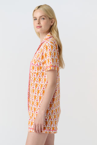 Playful orange monkeys and pink butterflies pop on a white background. The Monkey Polo Pajamas bring whimsy and color to your pima cotton collection, making this matching set a standout favorite for fun, lively sleepwear.