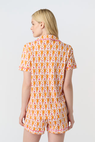 Playful orange monkeys and pink butterflies pop on a white background. The Monkey Polo Pajamas bring whimsy and color to your pima cotton collection, making this matching set a standout favorite for fun, lively sleepwear.