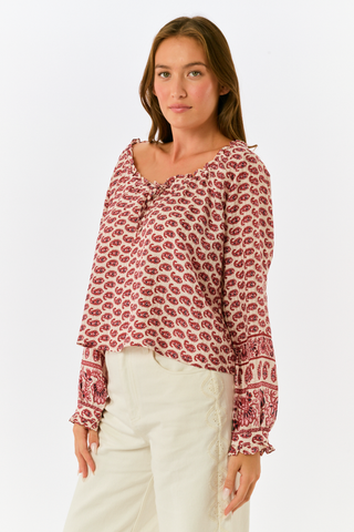 A long, tiered burgundy ornate paisley SAPPHIRE Ornate Paisley Carlisa Skirt worn with tan ankle boots.