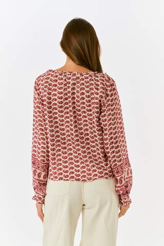 A long, tiered burgundy ornate paisley SAPPHIRE Ornate Paisley Carlisa Skirt worn with tan ankle boots.