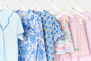 Children's clothing on hangers with colorful patterns