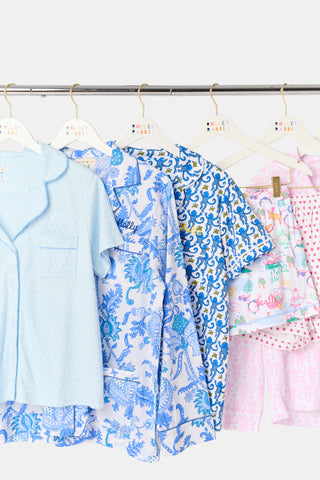 Children's clothing on hangers with a white background