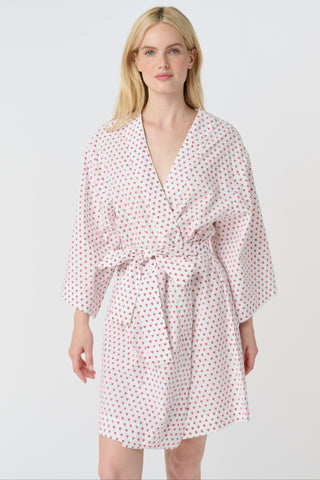 A woman stands barefoot, smiling in a Roller Rabbit Hearts Kimono with a matching belt, set against a plain white background.