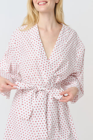 A woman stands barefoot, smiling in a Roller Rabbit Hearts Kimono with a matching belt, set against a plain white background.
