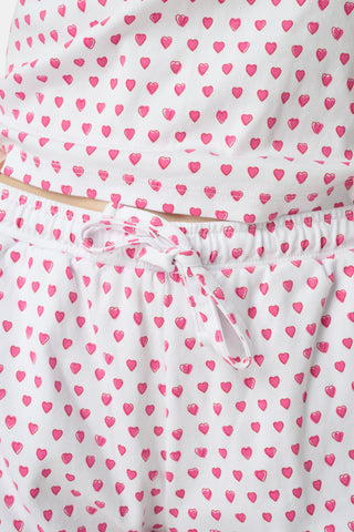 The Hearts Mischa Set is made from white Pima cotton with small, outlined pink hearts and a softly wrinkled texture, creating gentle shadows—perfect for cozy loungewear.