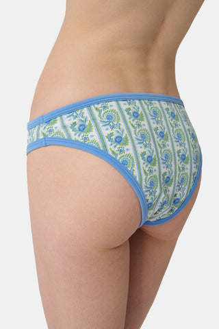 A person shown from the waist to upper thighs is wearing the Roller Rabbit Provencal Stripe Oceana Bikini Bottom featuring a blue and green floral design with light blue trim in a high-waisted bikini style.