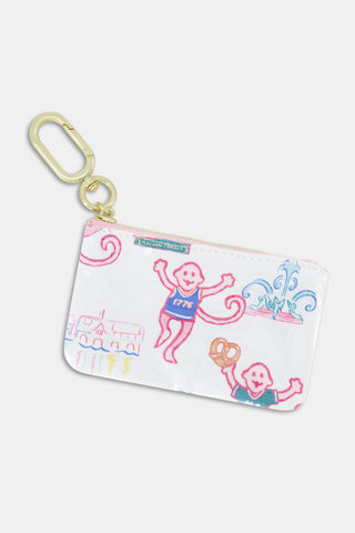 The Roller Rabbit Philly Monkey Coin Pouch is a white zippered coin bag adorned with pink and blue cartoon motifs—including figures, a fountain, a pretzel, and “1776” detail—and finished with a gold carabiner clip for playful style on the go.
