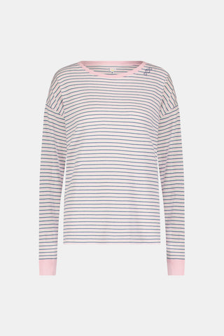 A woman wearing the Roller Rabbit Striped Brynn Oversized Tee—an ultra-comfy loungewear top with thin pink, blue, and white horizontal stripes and pink cuffs and collar—stands with one hand in her pocket against a plain background.