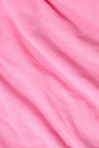 The Kids Ellis Cardigan by Roller Rabbit is a rose pink, long-sleeve cardigan featuring a ruffled collar and pearl-like buttons. Shown flat on a white background, it's made from soft cotton sweater material.