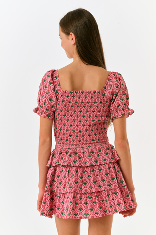 Kids Mia Floral Sami Skirt, a matching pink floral crop top and ruffled mini skirt with a smocked waistband.
