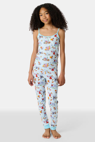 Young child with long brown hair stands barefoot, wearing the Roller Rabbit Kids Spain Monkey Noa Set—light blue Pima cotton loungewear with playful monkey prints and blue trim—against a plain white background.