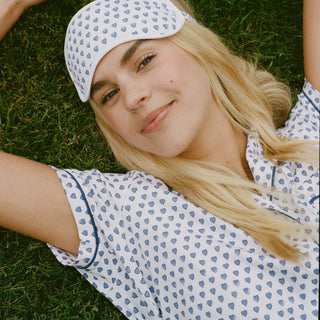Woman wearing a patterned headband and lying on grass