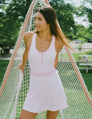 The Roller Rabbit Gingham Hearts Becky Active Dress is a sleeveless pink gingham dress featuring a fitted bodice, zipper front, and flared skirt, crafted from soft peached interlock fabric and shown on a plain white background.
