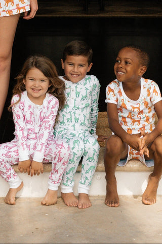 Three children in different colored Into the Wild pajamas.