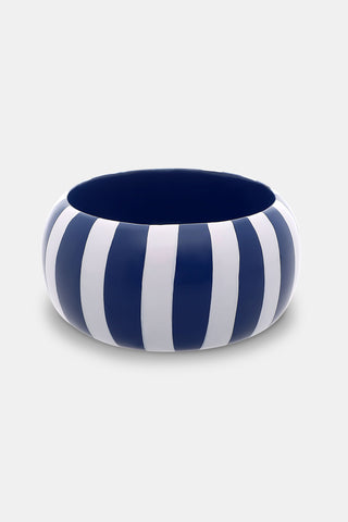 The Roller Rabbit Striped Bangle is a round, wide oversized bracelet featuring alternating vertical navy blue and white stripes, displayed on a plain light gray background.