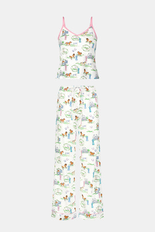The Saddle Up Joanie Pajamas by Roller Rabbit feature a white sleeveless top and long pants with pink trim. Both pieces are made from soft Pima cotton and decorated with colorful cartoon animal and house prints scattered across the fabric.