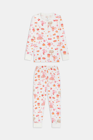 A girl wearing Roller Rabbit Kids Sweater Weather Pajamas stands barefoot, smiling, against a plain white background.