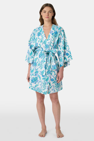 The Amanda Loungewear pajama set features white cotton fabric adorned with blue and turquoise floral and botanical patterns, adding a charming, intricate touch to women’s sleepwear.