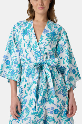 The Amanda Loungewear pajama set features white cotton fabric adorned with blue and turquoise floral and botanical patterns, adding a charming, intricate touch to women’s sleepwear.