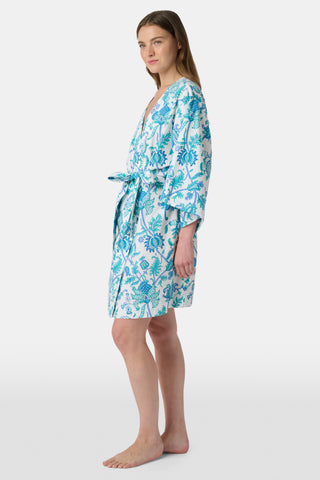 The Amanda Loungewear pajama set features white cotton fabric adorned with blue and turquoise floral and botanical patterns, adding a charming, intricate touch to women’s sleepwear.