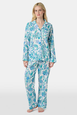 The Amanda Loungewear pajama set features white cotton fabric adorned with blue and turquoise floral and botanical patterns, adding a charming, intricate touch to women’s sleepwear.