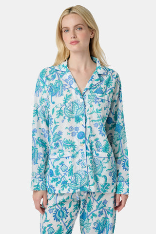 The Amanda Loungewear pajama set features white cotton fabric adorned with blue and turquoise floral and botanical patterns, adding a charming, intricate touch to women’s sleepwear.