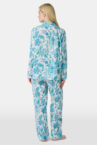 The Amanda Loungewear pajama set features white cotton fabric adorned with blue and turquoise floral and botanical patterns, adding a charming, intricate touch to women’s sleepwear.