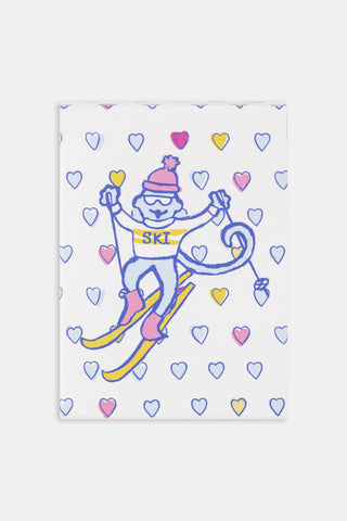Two Ski Monkey Playing Cards: one showing a cartoon ski monkey surrounded by heart icons, and one showing a traditional Queen of Hearts.