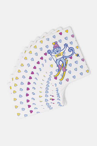 Two Ski Monkey Playing Cards: one showing a cartoon ski monkey surrounded by heart icons, and one showing a traditional Queen of Hearts.